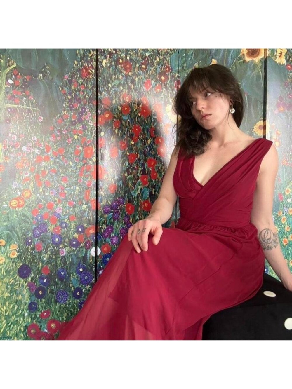 Red layered sheer gown with deep v neckline and flowy single slit skirt